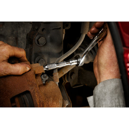 Person using a tool to work on a mechanical component.
