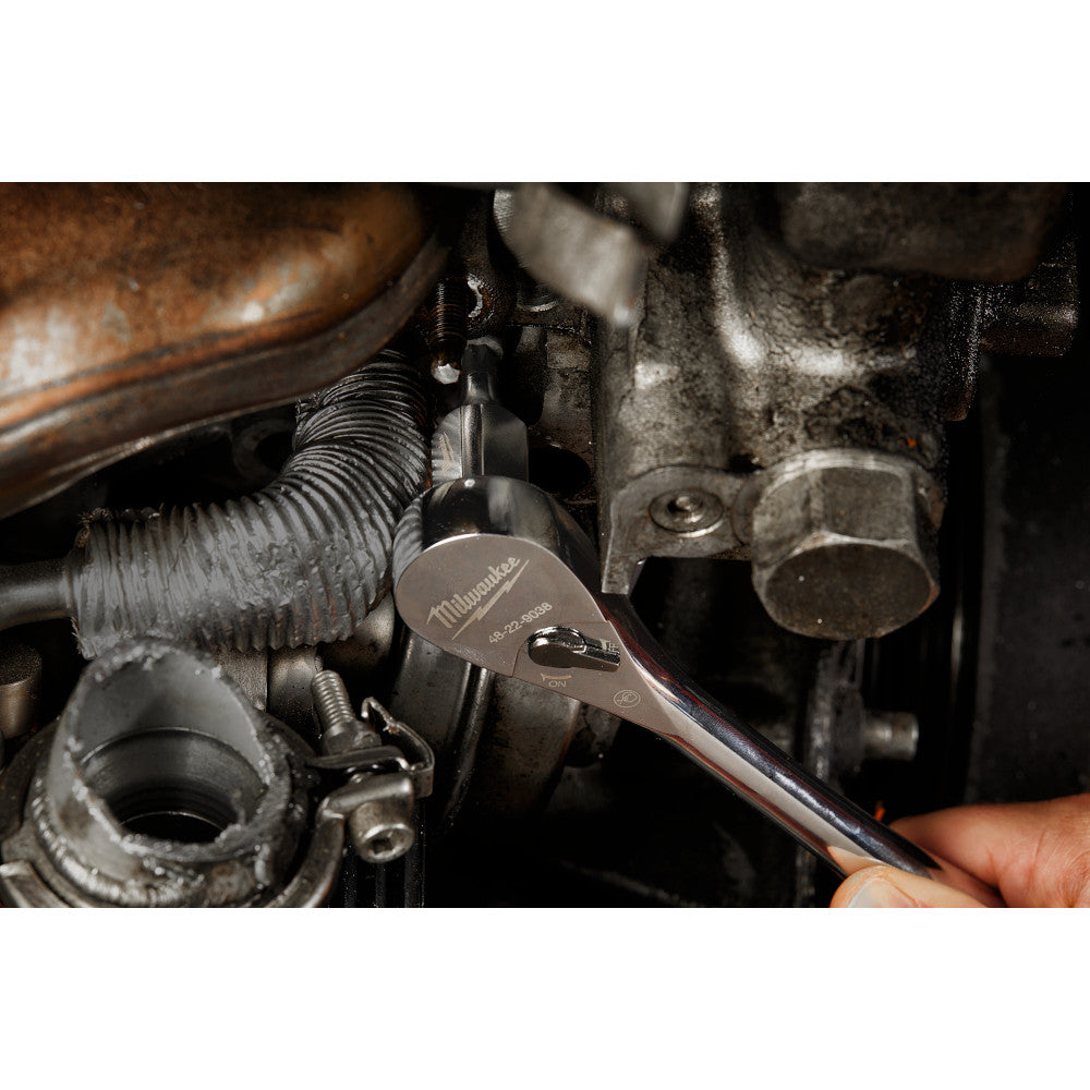 Close-up of a wrench working on engine components.