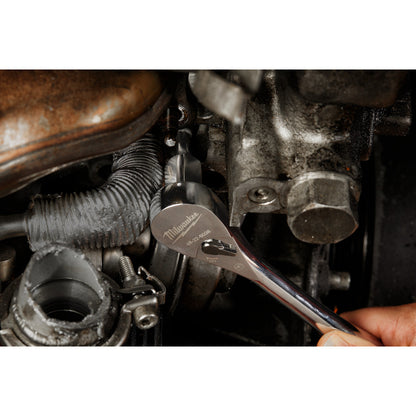 Close-up of a wrench working on engine components.