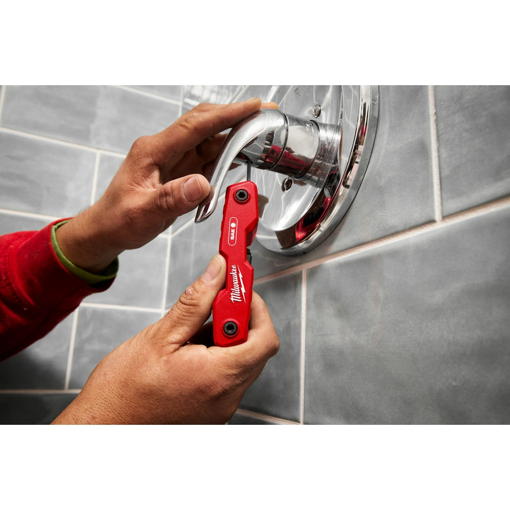 Person using the 9-Key Folding Hex Key Set - SAE on the jobsite