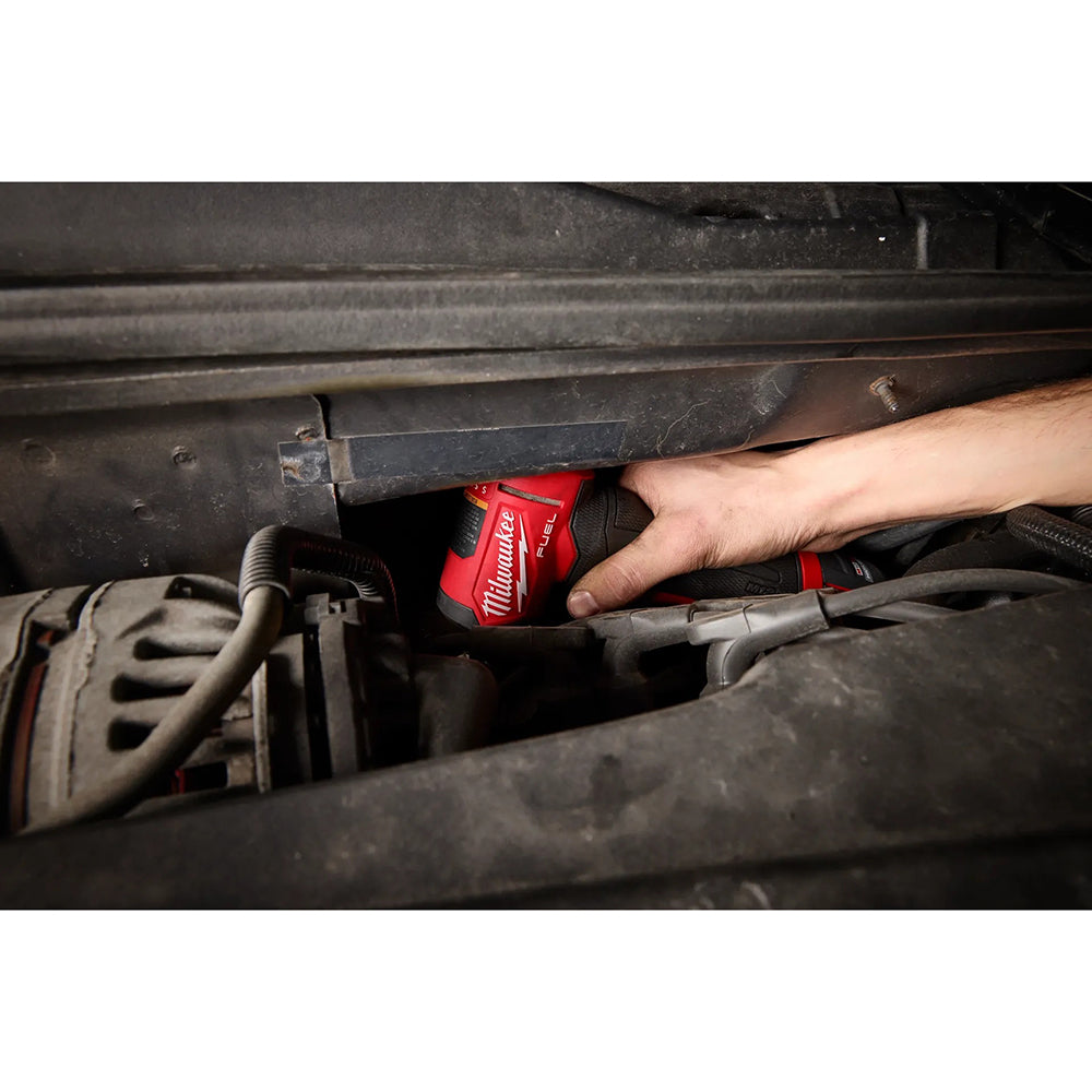 Person using a M12 FUEL™ 1/4" Right Angle Die Grinder under a vehicle