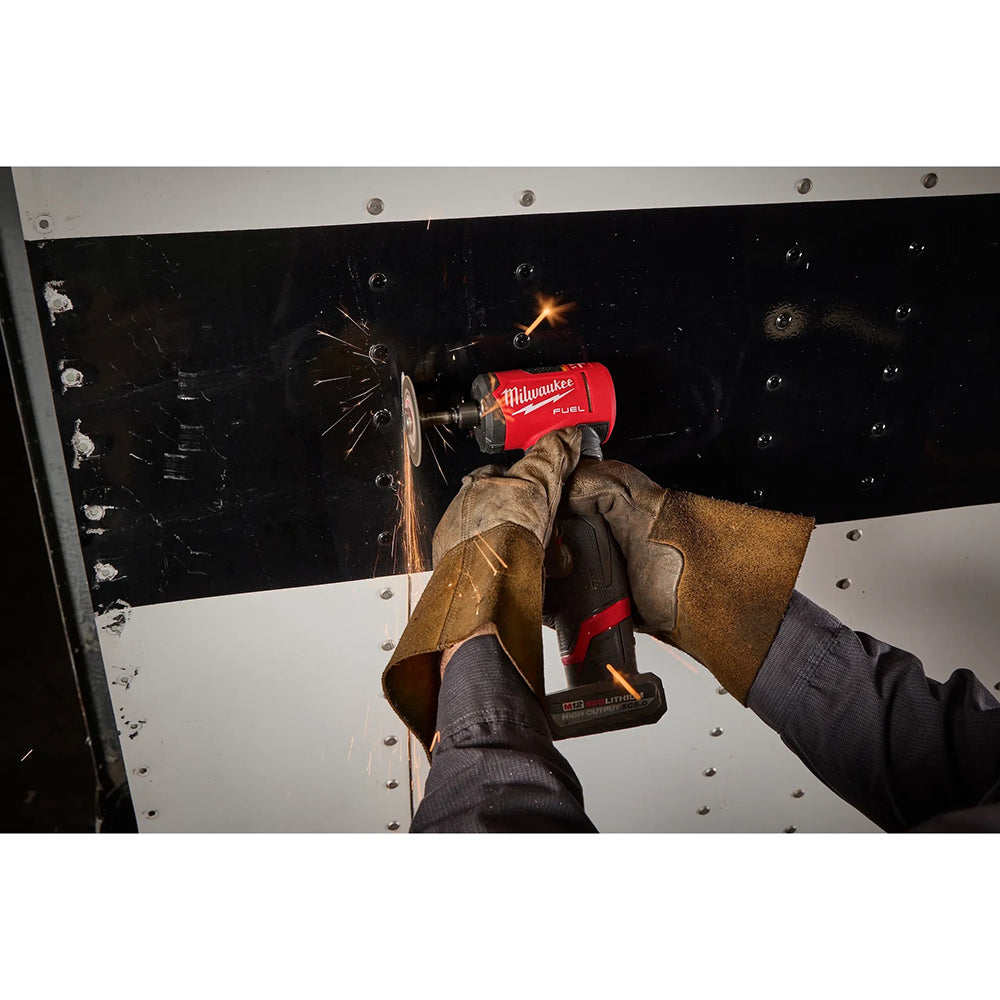 Person using a M12 FUEL™ 1/4" Right Angle Die Grinder on metal with sparks flying