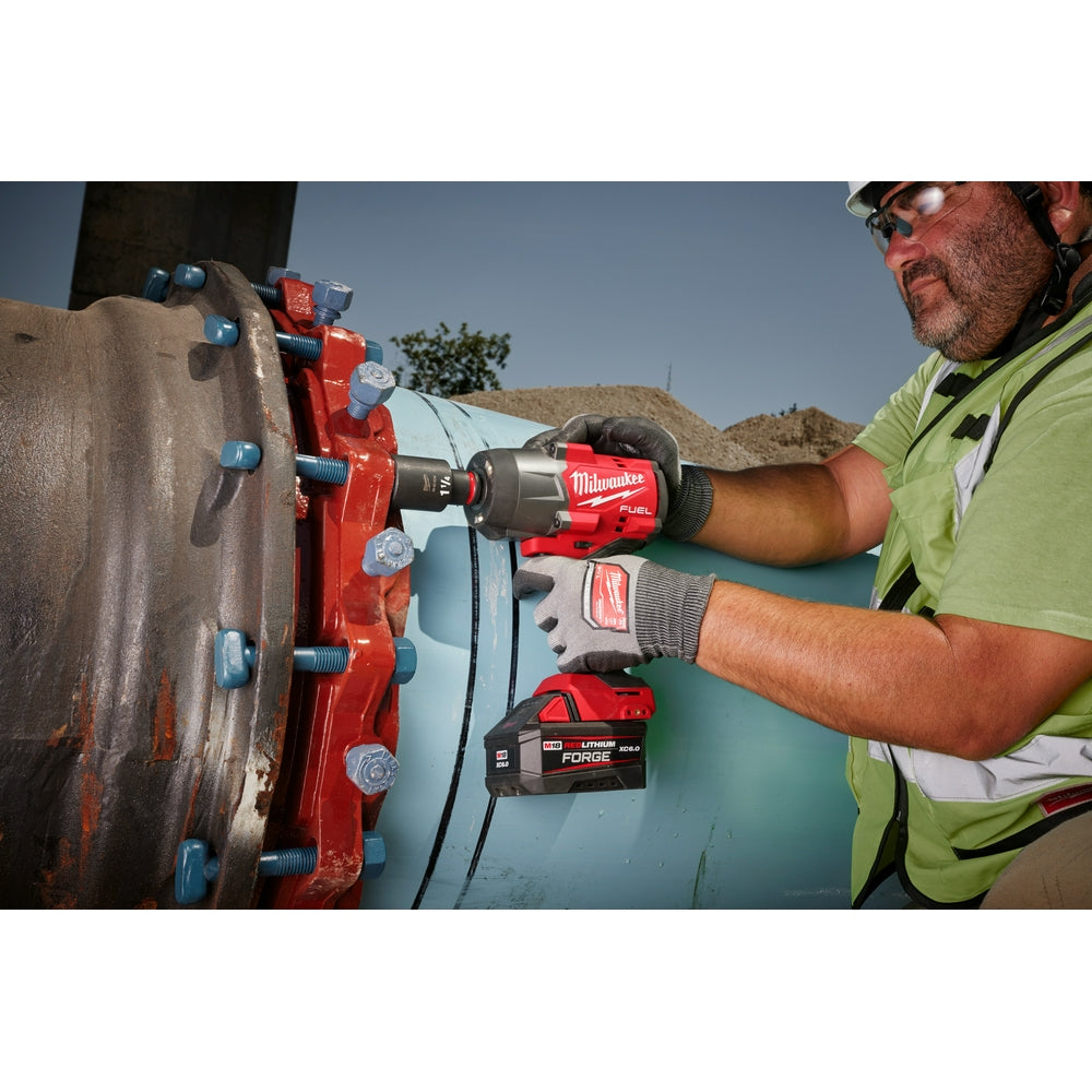 Person using a M18 FUEL™ 1/2" High Torque Impact Wrench w/ Friction Ring on a large mechanical component.