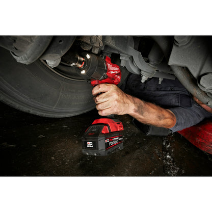Person using a M18 FUEL™ 1/2" High Torque Impact Wrench w/ Friction Ring under a vehicle.