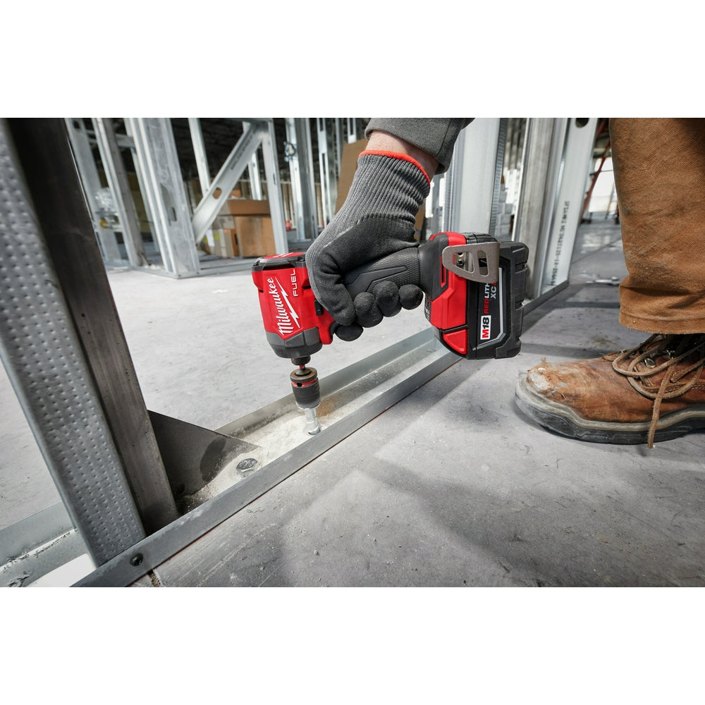 Person using a M18 FUEL™ 1/4" Hex Impact Driver on a construction site.