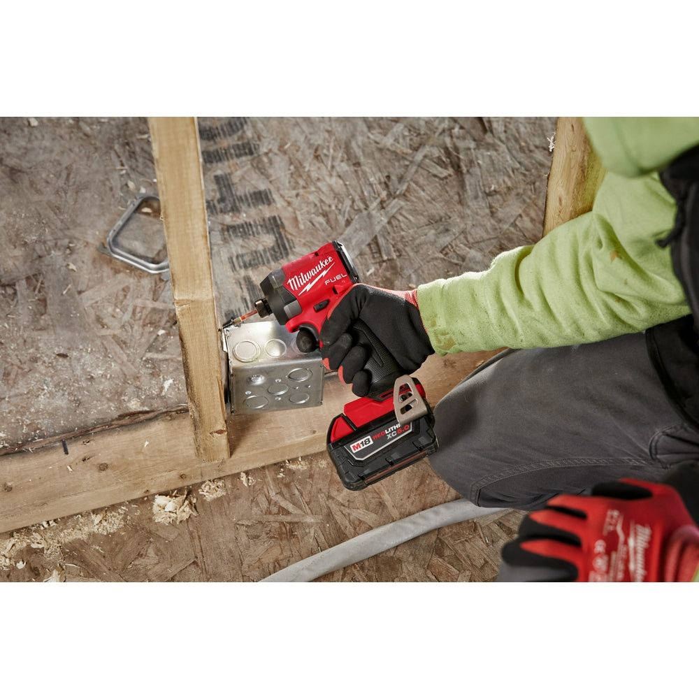 Person using the M18 FUEL™ 1/4" Hex Impact Driver on a construction site