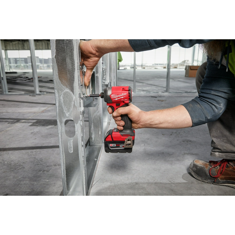 Person using the M18 FUEL™ 1/4" Hex Impact Driver on a construction site