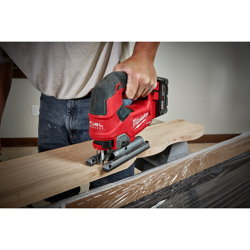 Person using a M18 FUEL™ D-handle Jig Saw tool on a piece of wood.