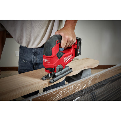 Person using a M18 FUEL™ D-handle Jig Saw tool on a piece of wood.