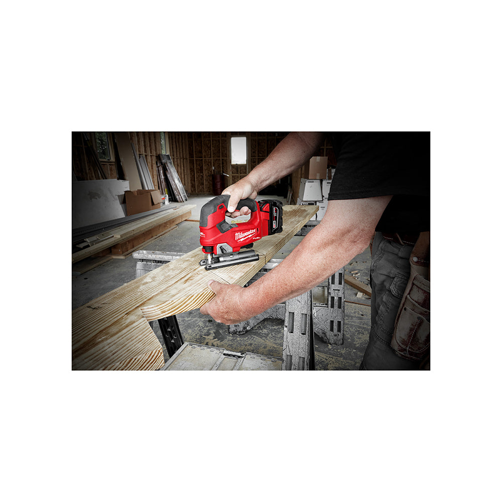 Person using a M18 FUEL™ D-handle Jig Saw on a wooden surface in a workshop setting