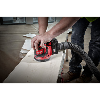 Person using a M18™ Random Orbit Sander on a wooden surface.