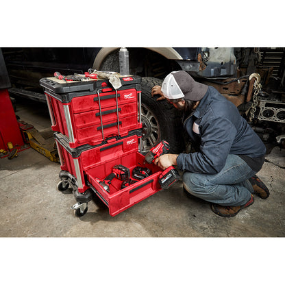 Person using a PACKOUT™ 2-Drawer Tool Box in a garage setting