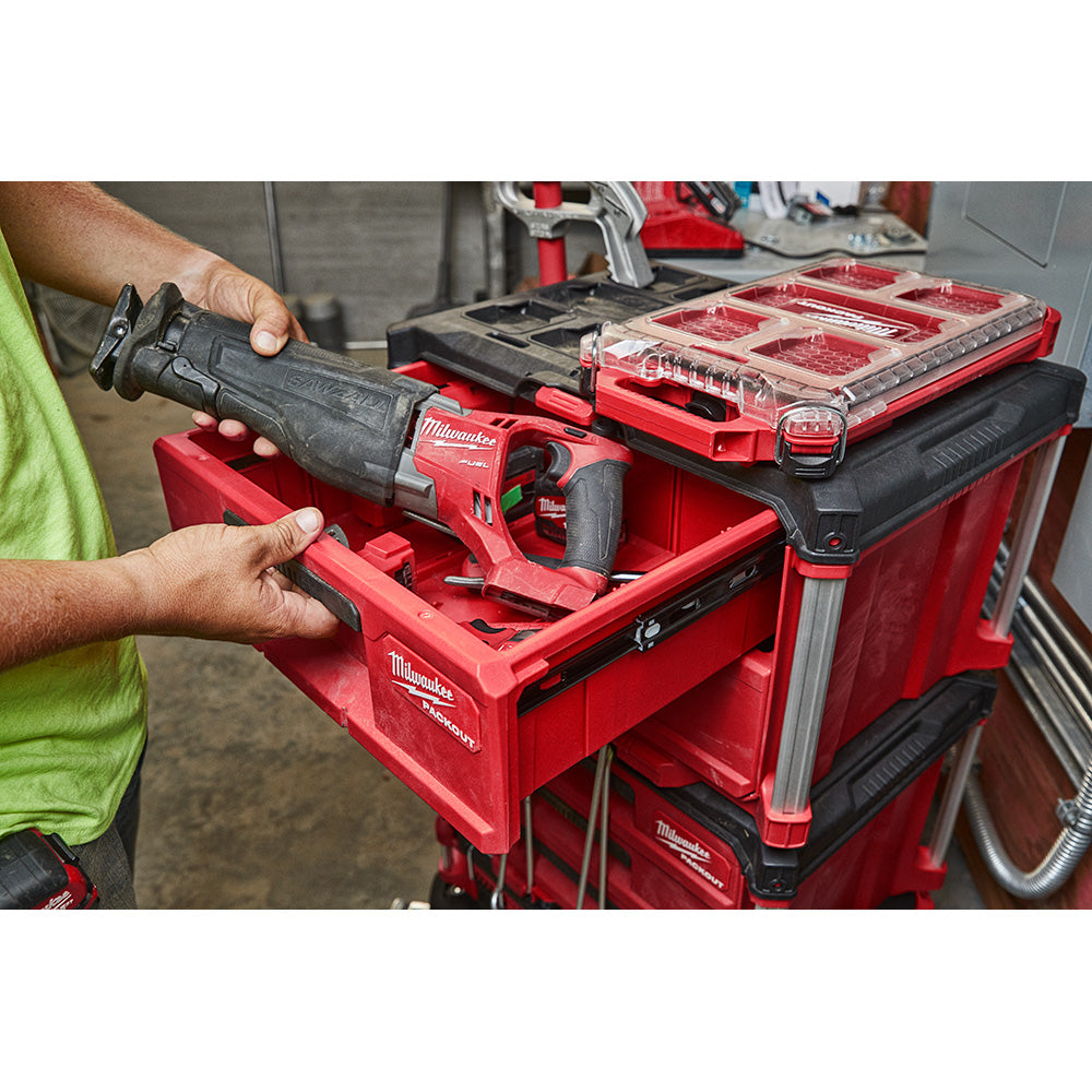 Person using a PACKOUT™ 2-Drawer Tool Box with various tools inside.
