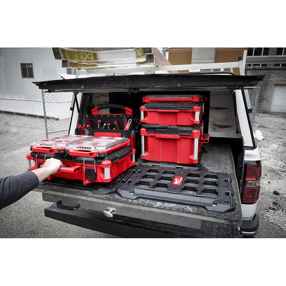 Truck bed with red PACKOUT boxes and tools.