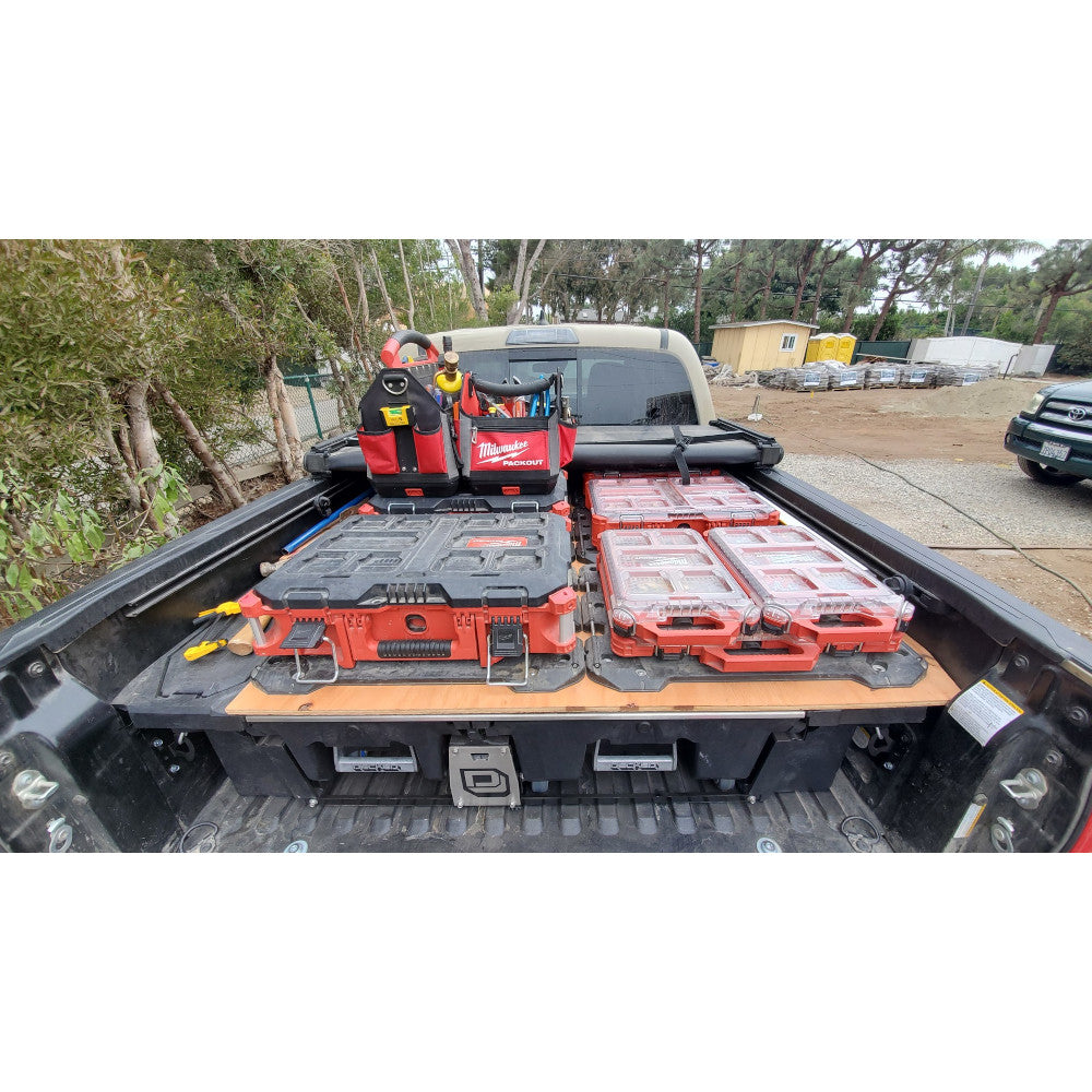 PACKOUT™ boxes and equipment in the back of a truck outdoors.