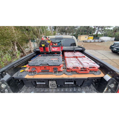 PACKOUT™ boxes and equipment in the back of a truck outdoors.